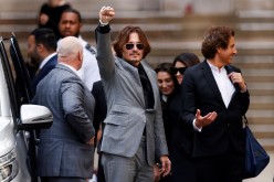 Actor Johnny Depp gestures as he leaves the High Court in London, Britain