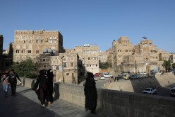 People walk in the old quarter of Sanaa, Yemen 