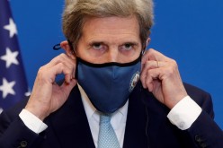 U.S. Special Presidential Envoy for Climate John Kerry adjusts his protective face mask as he attends a joint news conference 