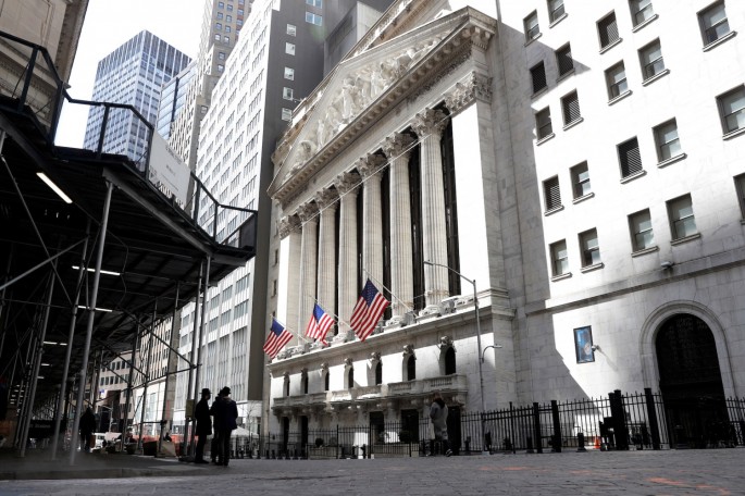 People are seen on Wall St. outside the New York Stock Exchange (NYSE) in New York City, U.S.,