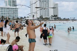 Tourists enjoy a public beach in Cancun, Mexico March 9, 2021. Picture taken