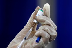 A paramedic prepares a dose of Sinopharm's coronavirus disease (COVID-19) vaccine before administering it to a resident, at a vaccination center in Karachi, 