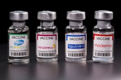 Vials with Pfizer-BioNTech, AstraZeneca, Sputnik V, and Moderna coronavirus disease (COVID-19) vaccine labels are seen 