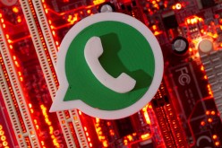 A 3D printed Whatsapp logo is placed on a computer motherboard in this illustration taken