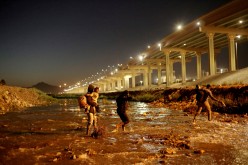 Migrants cross the Rio Bravo river to turn themselves in to U.S Border Patrol agents to request for asylum in El Paso, Texas, U.S.,