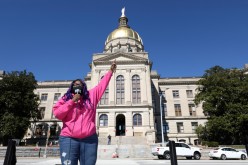 Kimberly Latrice Jones speaks during a gathering outside of the Georgia State Capitol to protest HB 531, which would place tougher restrictions on voting in Georgia, 