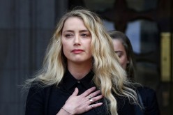 Actor Amber Heard delivers a statement as she leaves the High Court in London, Britain