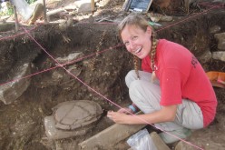 Archeologist Amy Thompson excavates at the ancient Maya site of Uxbenka, Belize in April 2012.