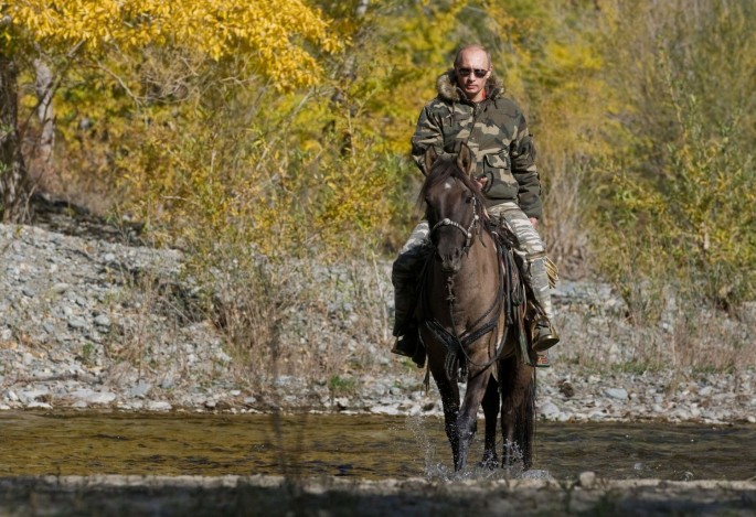 Russia's Prime Minister Vladimir Putin rides a horse as he takes part in an expedition to Ubsunur Hollow Biosphere Preserve to inspect the snow leopard's habitat
