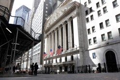 People are seen on Wall St. outside the New York Stock Exchange (NYSE) in New York City, U.S.