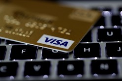 A Visa credit card is seen on a computer keyboard in this picture illustration taken