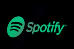 The Spotify logo is displayed on a screen on the floor of the New York Stock Exchange (NYSE) in New York, U.S.,
