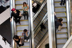 Shoppers ride escalators at the Beverly Center mall in Los Angeles, California 