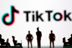 Small toy figures are seen in front of TikTok logo in this illustration picture taken