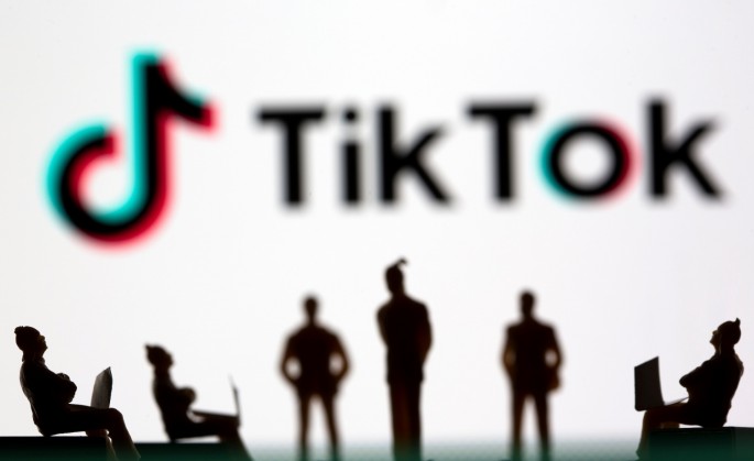 Small toy figures are seen in front of TikTok logo in this illustration picture taken