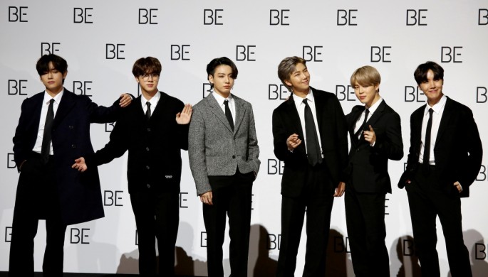 Members of K-pop boy band BTS pose for photographs during a news conference promoting their new album "BE(Deluxe Edition)" in Seoul, 
