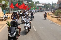 People take part in a motorcycle parade during a protest against the military coup, in Launglon township,