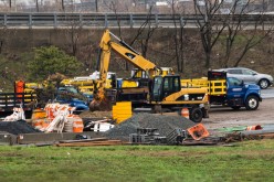 Materials and trucks to fix roads are seen over a local road in Newark, New Jersey, U.S.