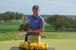 Apr 4, 2021; San Antonio, Texas, USA; Jordan Spieth holds the trophy after winning the Valero Texas Open golf tournament.