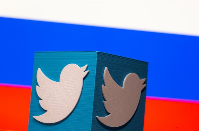 A 3D-printed Twitter logo is pictured in front of a displayed Russian flag in this illustration taken 