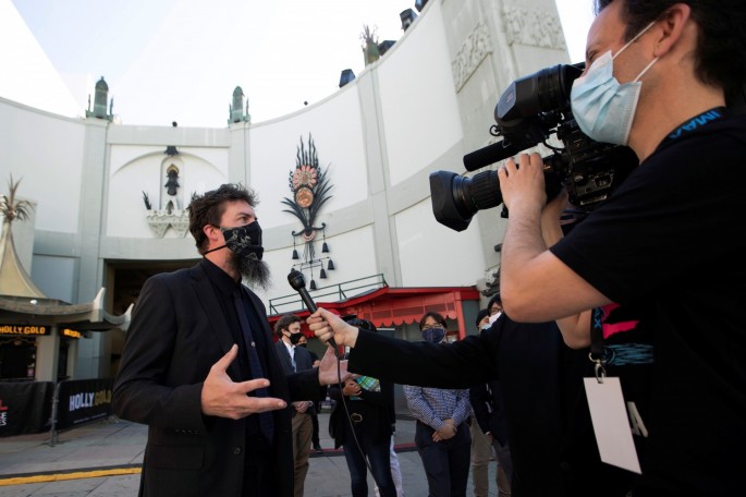 Adam Wingard, director of the upcoming movie "Godzilla vs. Kong", is interviewed at a ribbon cutting ceremony ahead of the reopening of the TCL Chinese theatre 