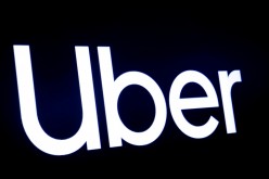 A screen displays the company logo for Uber Technologies Inc at the New York Stock Exchange (NYSE) in New York, U.S