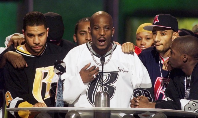 Rapper DMX (C) offers a prayer after winning the R&B Albums Artist of the Year award at the Billboard Music Awards show at the MGM Grand Hotel 