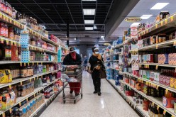 Shoppers browse in a supermarket while wearing masks to help slow the spread of coronavirus disease (COVID-19) in north St. Louis