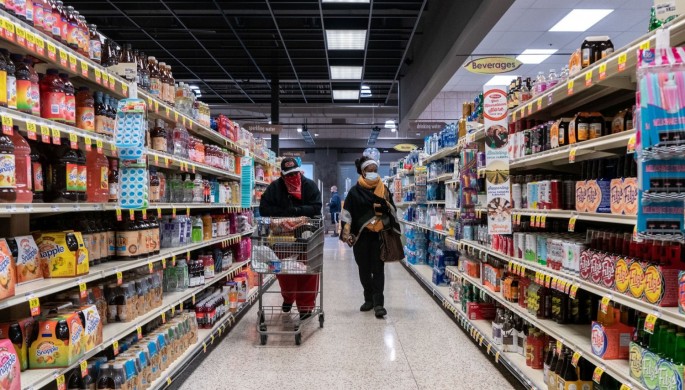 Shoppers browse in a supermarket while wearing masks to help slow the spread of coronavirus disease (COVID-19) in north St. Louis