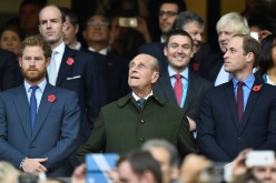 Britain's Prince Harry, Prince Philip and Prince William (L-R) attend the Rugby World Cup final match between New Zealand against Australia at Twickenham in London, 