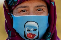 An Ethnic Uighur demonstrator wearing a protective face mask takes part in a protest against China, in Istanbul, Turkey