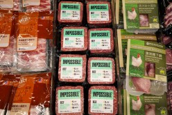 Impossible Foods plant-based beef products are seen in between other meat products inside a refrigerator at a supermarket in Hong Kong, China