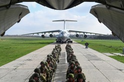 Service members of the Russian airborne forces board an Ilyushin Il-76 transport plane during drills at a military aerodrome in the Azov Sea port of Taganrog, Russia