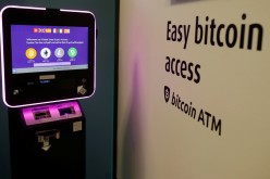 The exchange rates and logos of Bitcoin (BTH), Ether (ETH), Litecoin (LTC) and Bitcoin Cash (BCH) are seen on the display of a cryptocurrency ATM of blockchain payment service provider