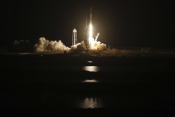 A SpaceX Falcon 9 rocket, with the Crew Dragon capsule, is launched carrying four astronauts on a NASA commercial crew mission to the International Space