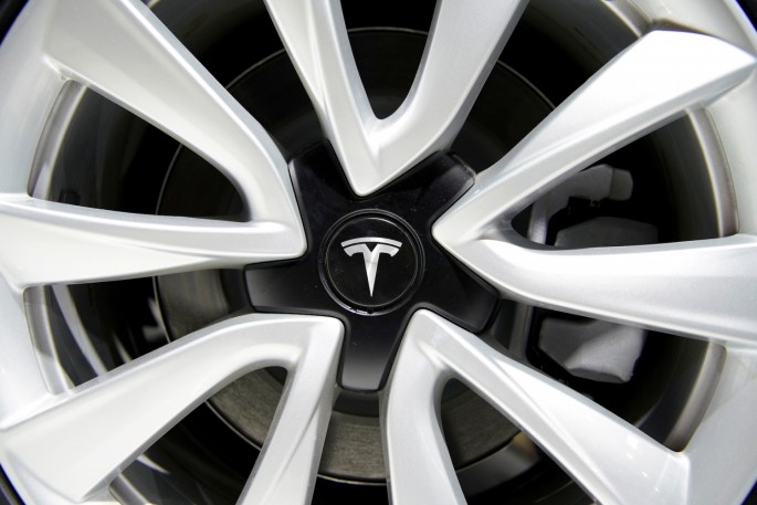 A Tesla logo is seen on a wheel rim during the media day for the Shanghai auto show in Shanghai, China