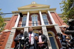 Wayne Kendall, lawyer for the family of Andrew Brown Jr., speaks outside the courthouse while fellow attorneys Harry Daniels (L) and Chantel Cherry-Lassiter listen after a judge
