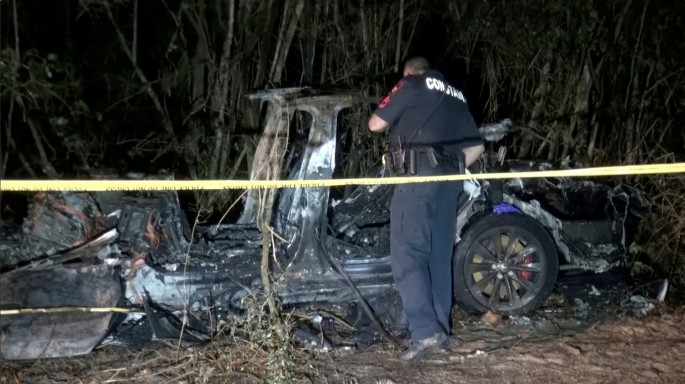 The remains of a Tesla vehicle are seen after it crashed in The Woodlands, Texas, April 17, 2021, in this still image from video obtained via social media. 