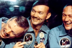 Apollo 11 astronauts Neil Armstrong (L), Michael Collins and Buzz Aldrin smile through the window of the mobile quarantine van in this NASA handout image