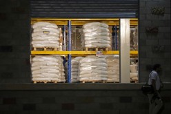 A man walks past aid at a warehouse where international humanitarian aid for Venezuela is being stored, during a visit by U.S. Secretary of State Mike Pompeo and Colombia’s President Ivan Duque,