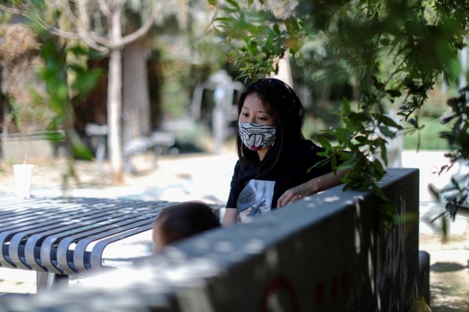 Tracy Park sits in the park in which she was shouted at with her daughter, as the coronavirus disease (COVID-19) pandemic continues, in Hollywood, Los Angeles, California, U.S.