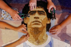 Gabriela Pereyra, Paula Soto, ad Gonzalo Lopez Lluch, members of the cultural organisation Comando Maradona, prepare a mosaic 