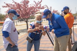 A fan shows a vaccine passport on her phone as she arrives for a New York Mets game, during the coronavirus disease (COVID-19) pandemic,