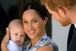 Britain's Prince Harry and his wife Meghan, Duchess of Sussex holding their son Archie, meet Archbishop Desmond Tutu (not pictured) at the Desmond & Leah Tutu Legacy 