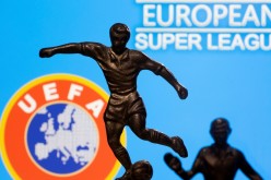 Metal figures of football players are seen in front of the words 
