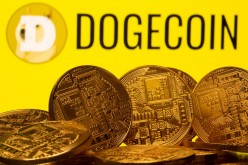 Cryptocurrency representations are seen in front of the Dogecoin logo in this illustration picture taken 