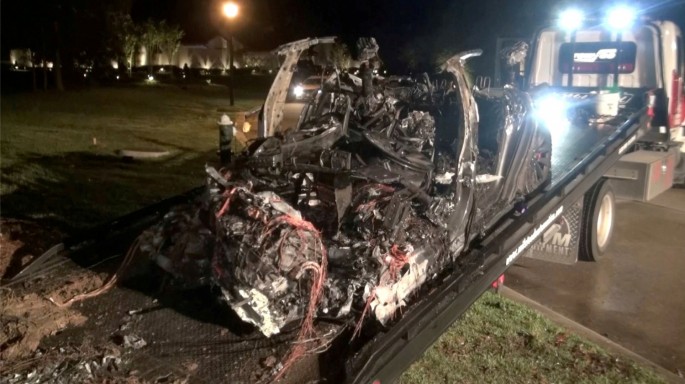 The remains of a Tesla vehicle are seen after it crashed in The Woodlands, Texas, April 17, 2021, in this still image from video obtained via social media.
