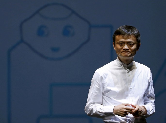 Jack Ma, founder and executive chairman of China's Alibaba Group, speaks in front of a picture of SoftBank's human-like robot named 'pepper' 