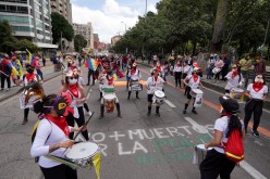 Demonstrators play drums during a protest demanding government action to tackle poverty, police violence and inequalities in healthcare and education systems, in Bogota