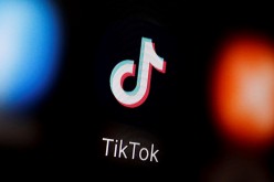 A TikTok logo is displayed on a smartphone in this illustration taken